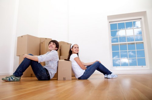 Packed boxes and household items being loaded into a removal truck