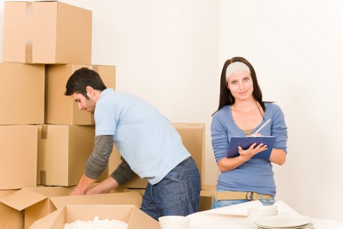 Professional packers organising household items for safe transport