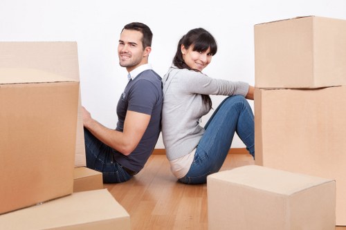 Packed household boxes and furniture ready for transport in Maze Hill