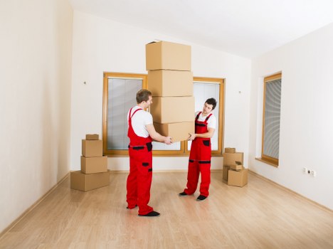 Office furniture and archive boxes being prepared for transport