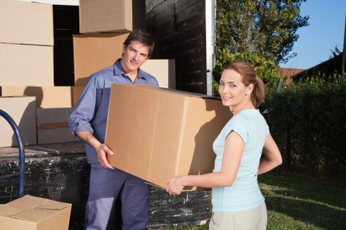 Local movers loading boxes for a property relocation in Maze Hill