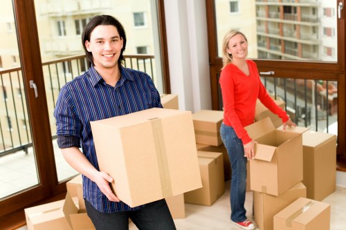 Packers securing furniture and protecting floors before transit